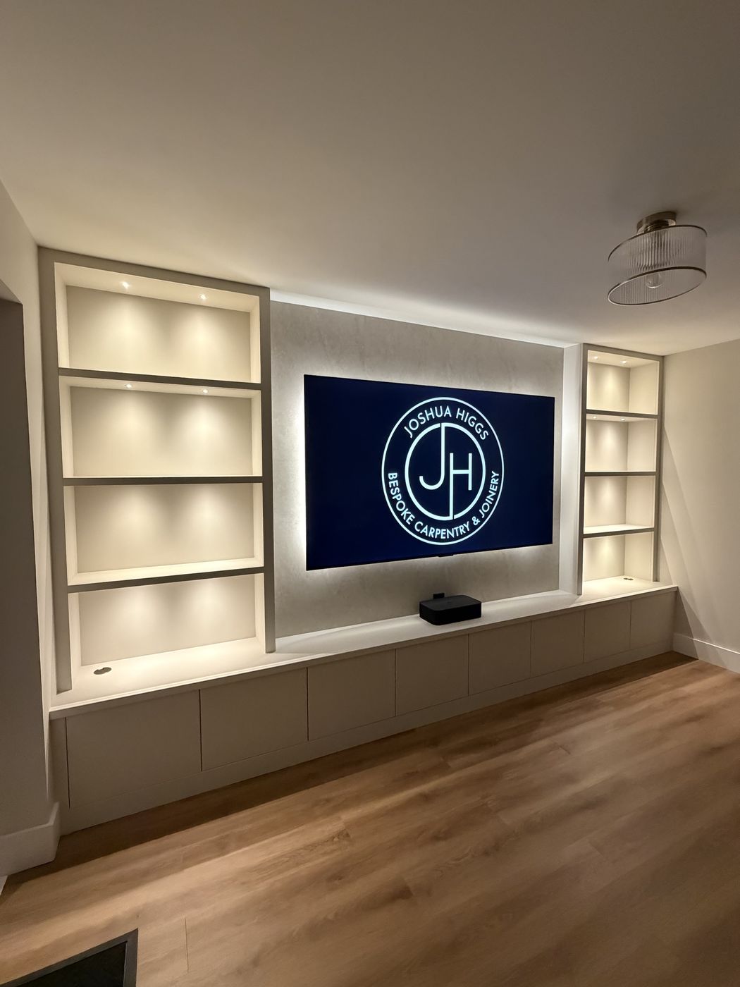 Lit alcove shelving media wall